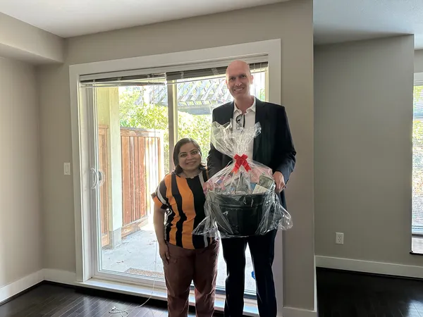 Kyle delivering a gift basket to a new homeowner