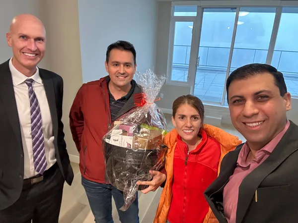 Kyle with happy clients in their new condo